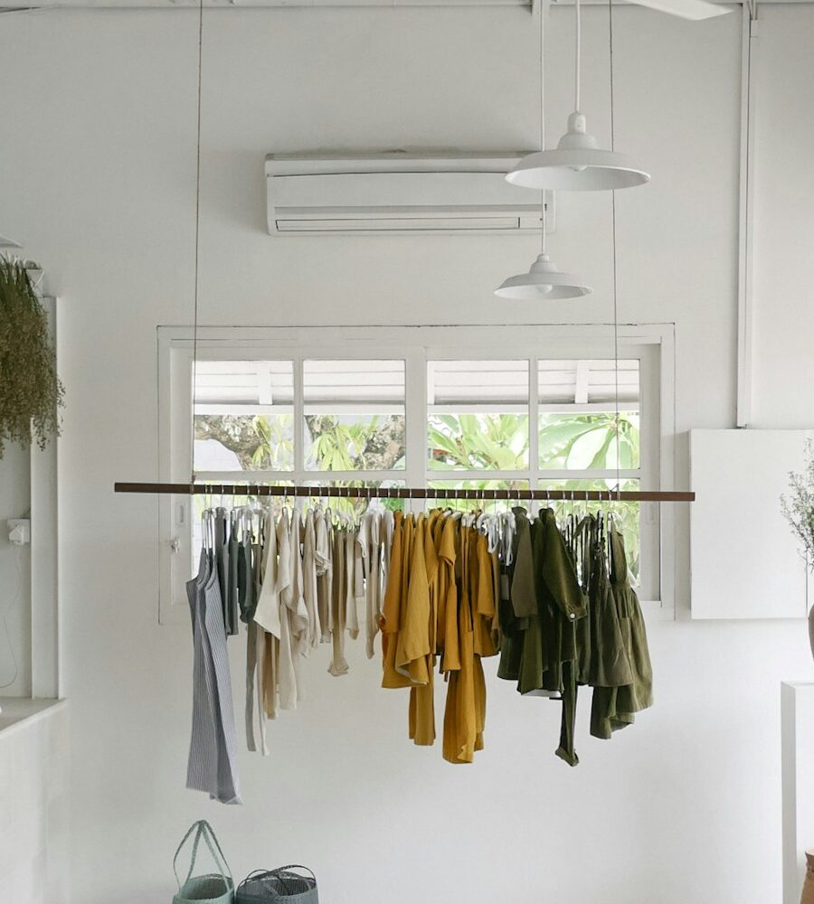 Freshly cleaned garments hanging in a bright, airy boutique space