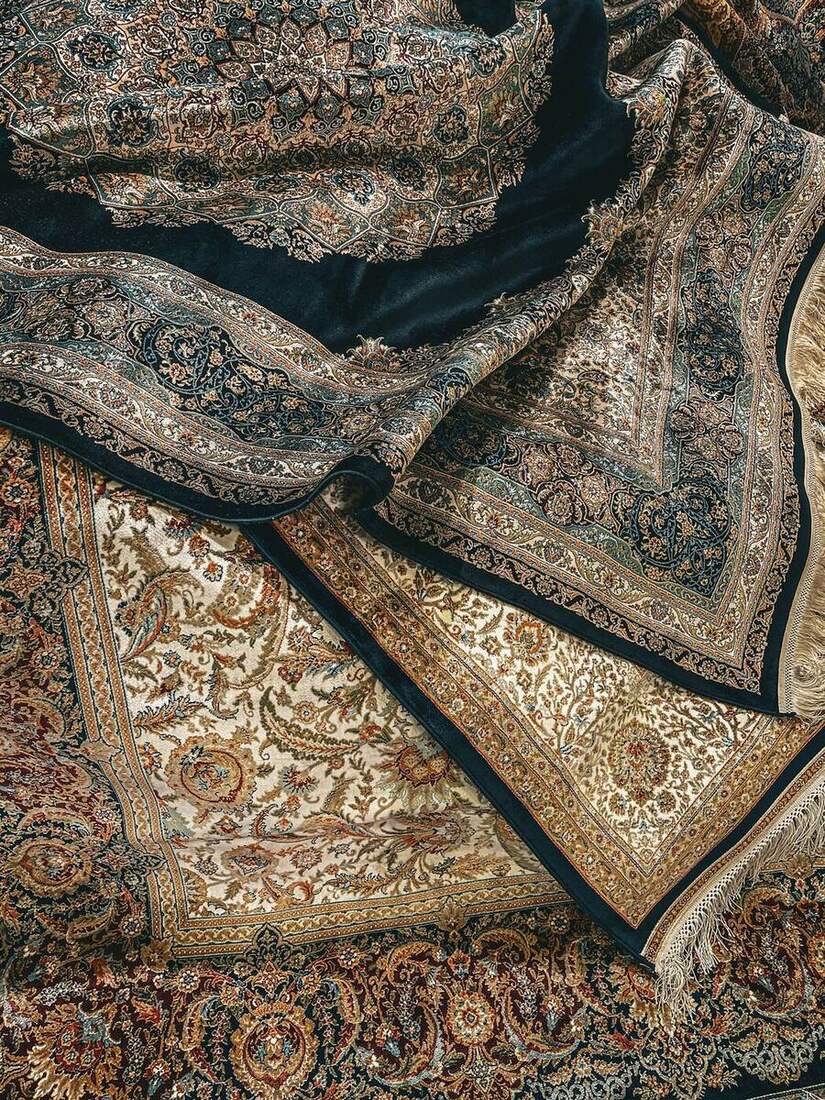 Layered oriental area rugs with intricate patterns